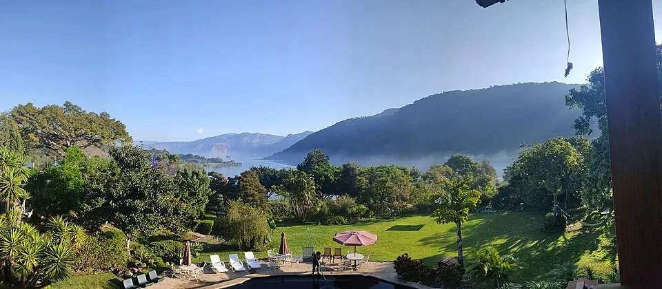A misty view of Lake Atitlan and its surrounding hills from a garden terrace near San Lucas Toliman.